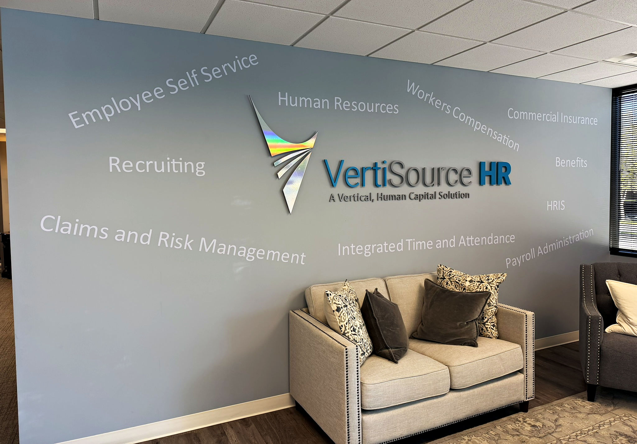The VertiSource HR logo wall in the reception lobby of the company&rsquo;s Cottonwood Heights, Utah headquarters