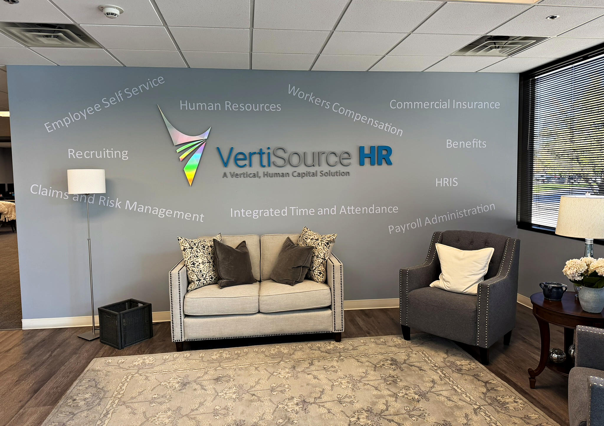 The reception lounge and logo wall at VertiSource HR&rsquo;s headquarters in Cottonwood Heights, Utah