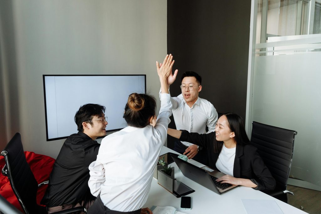 employees high five each other