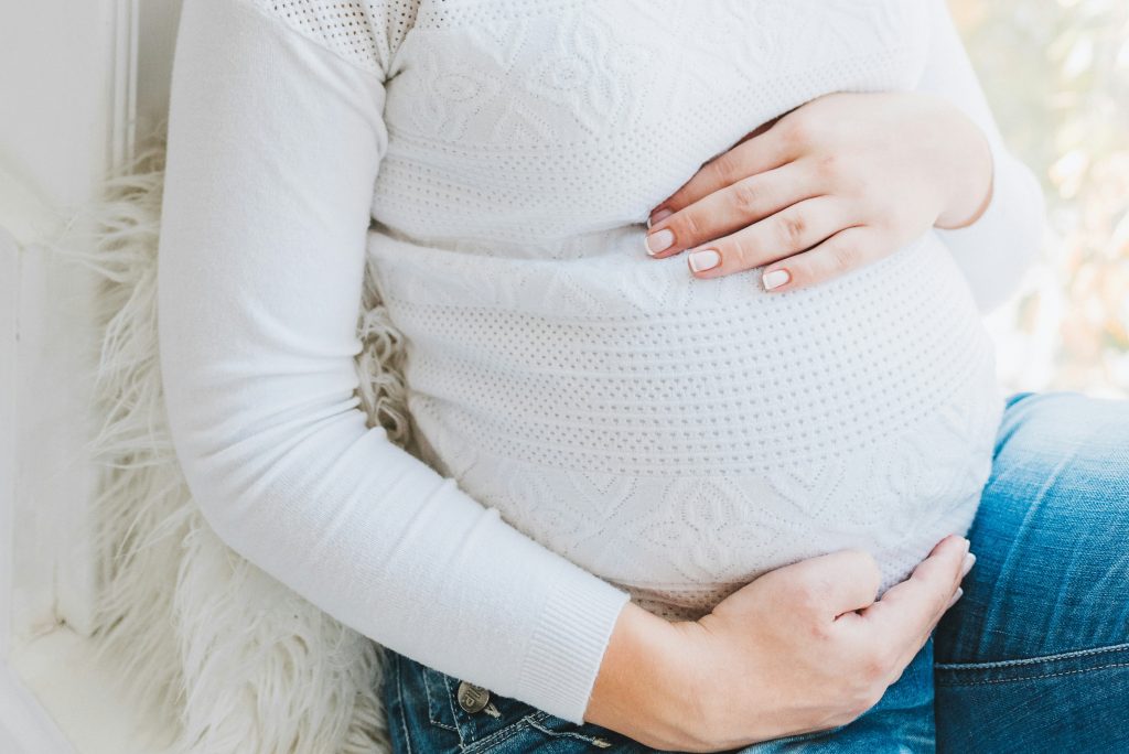 pregnant woman holding her bump