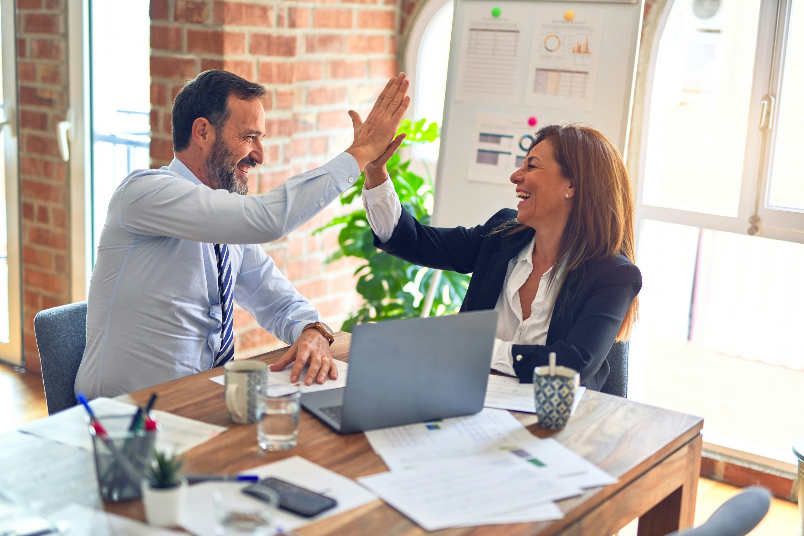 coworkers high fiving each other